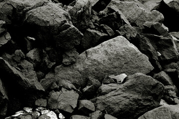 Cliff stone pieces background in black and white. Stones background in a low key.