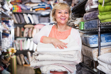 housewife adult woman buyer with tablecloths in the shop