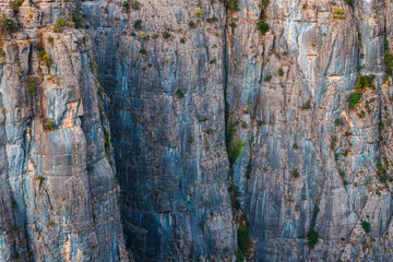 Close-up abstract view of rock and cliff as background or texture element. Concept of natural attractions and gorges and canyons and rock climbing