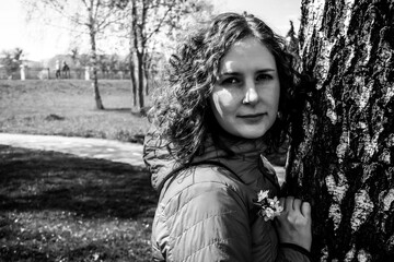 spring girl portrait over tree, black and white photo