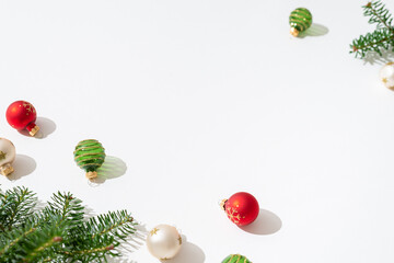Christmas composition. Balls and fir tree branches on white background. Christmas, winter, new year minimal concept. Side view, copy space. Greeting card, wallpaper