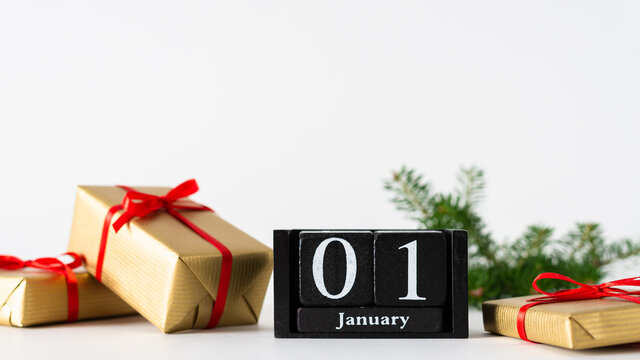 January 1st. Day 1 of january month, calendar with gift boxes and fir branches on white background. Winter time. Happy New year concept. New start. Copy space