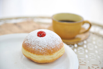 Hanukkah symbol jewish food holiday image of donut with jelly and sugar powder.