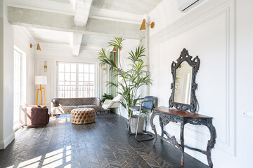 Chic, luxurious guest room design with old-fashioned antique furniture. white walls are decorated with relief. there is a beautiful dark brown parquet on the floor.