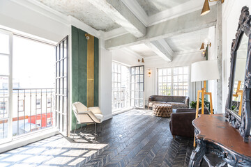Chic, luxurious guest room design with old-fashioned antique furniture. white walls are decorated with relief. there is a beautiful dark brown parquet on the floor.