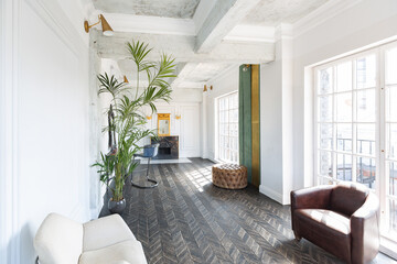 Chic, luxurious guest room design with old-fashioned antique furniture. white walls are decorated with relief. there is a beautiful dark brown parquet on the floor.