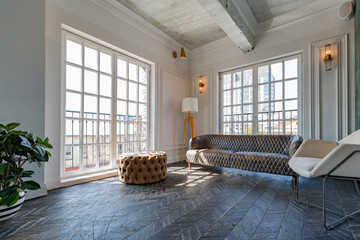 Chic, luxurious guest room design with old-fashioned antique furniture. white walls are decorated with relief. there is a beautiful dark brown parquet on the floor.