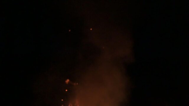 Flames and smoke late in the evening, slowing down the fire and smoke on a dark background.2020