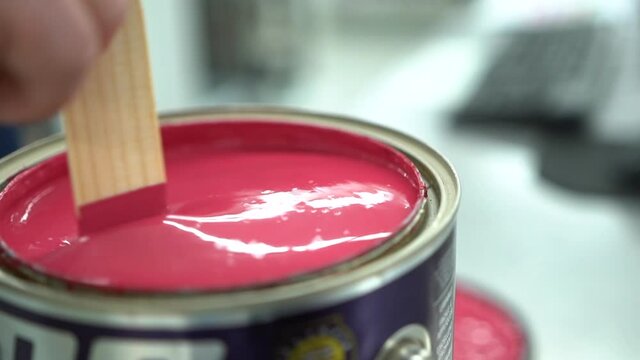 Mixing paint with a wooden stick