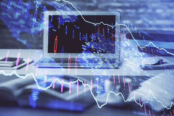 Financial chart drawing and table with computer on background. Multi exposure. Concept of international markets.