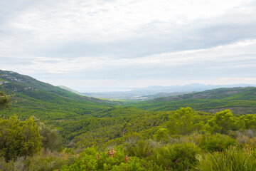 Obraz premium Serra d'Irta natural park, Alcossebre, Costa del Azahar, Spain. Beautiful protected area, contrasted by mountains and clouds. Located between Alcossebre and Peniscola, near the Mediterranean sea. 