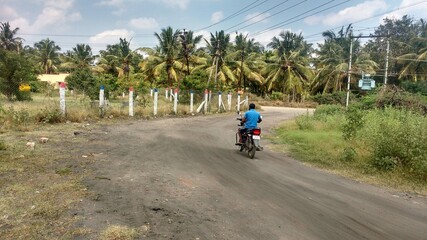 Fototapeta premium person riding a bike on mud road