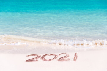 2021 written on the sand of a beach, travel 2020 new year concept