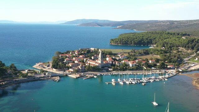 Beautiful old historic town of Osor, marina and bridge connecting islands Cres and Losinj, Croatia, aerial footage from drone