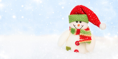 Snowman toy on the bokeh winter background . Christmas background. Copy space for text