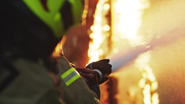 Fireman extinguish fire with the hose. Burning house fire drill. High quality 4k footage