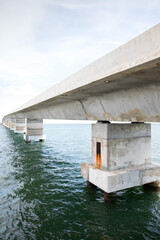 Fototapeta na wymiar Concrete bridge over blue ocean water