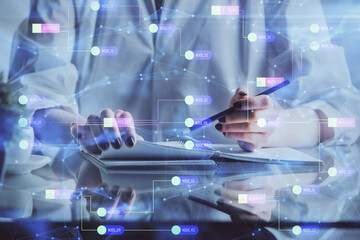 Fototapeta premium Multi exposure of hands making notes with digital coding icons. Computer learning concept.