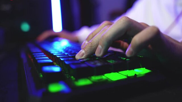 Male hands of a young gamer playing an online game