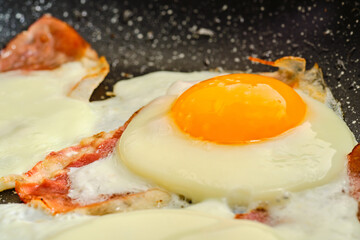 Cooking fried eggs with  bacon