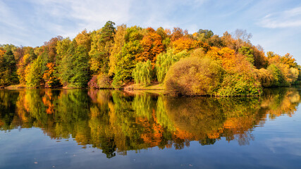 Panorama of the autumn Park. Beautiful autumn landscape with red trees by the lake. Tsaritsyno, Moscow