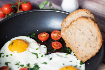 
Fried eggs in a frying pan.
