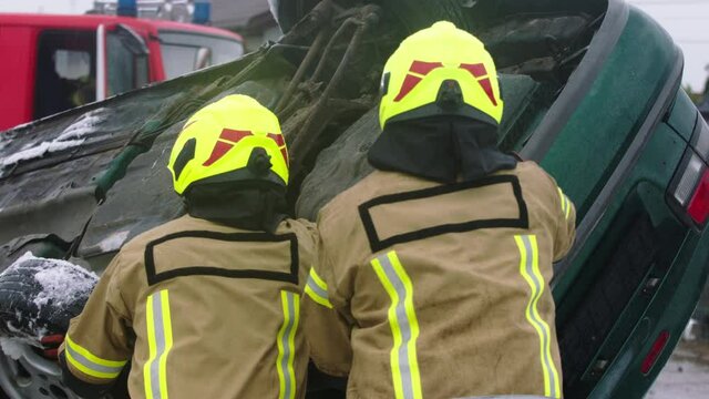 Firefighters turning the car after car crash accident. High quality 4k footage