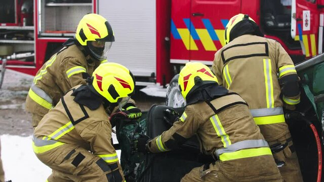 Firefighters cutting car doors to rescue viction of the car crash accident. High quality 4k footage