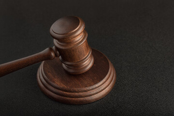 Gavel and sounding block on black background close up. Justice and law concept.