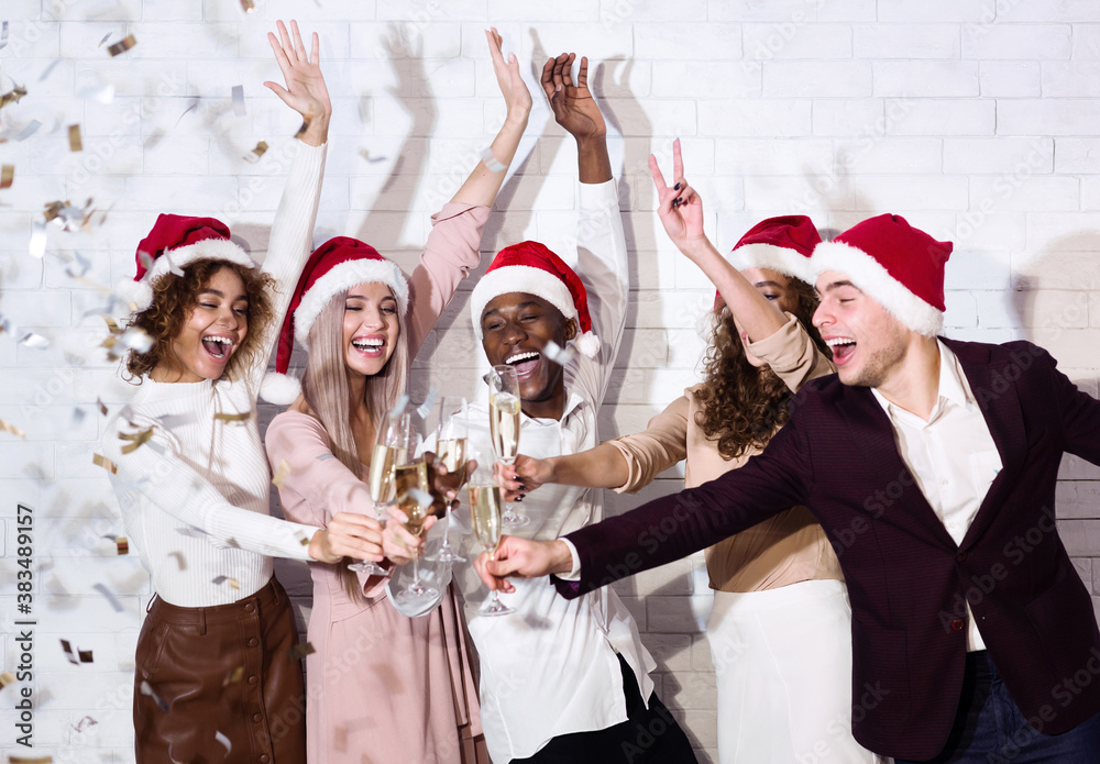 Wall mural Joyful Friends Clinking Glasses Having Party With Confetti Indoors