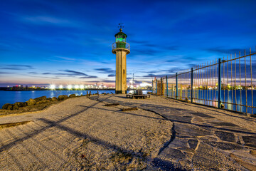 lighthouse in the port at sunset
