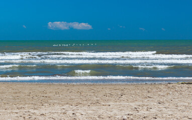 Sandy beach of the Adriatic Sea in calm, clear weather. Rimini, Italy