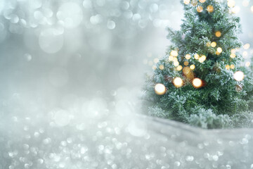 Christmas winter bokeh background. Christmas tree with snow and abstract bokeh lights. Festive...