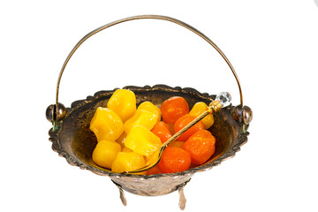 dried fruits in retro brass bowl isolated on white background