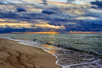 Beautiful sunset in the clouds on the sea