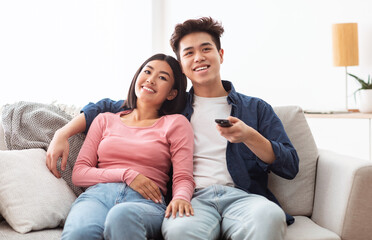 Obraz premium Asian Family Couple Watching Movies On TV Relaxing At Home