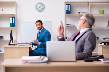 Two male colleagues working in the office