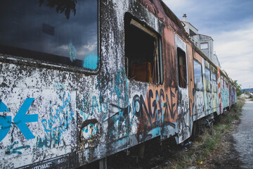 abandoned rusty trains painted with graffiti