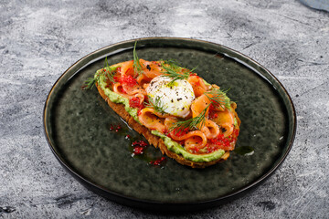 Open sandwich with salted red fish, poached egg, balsamic vinegar and micro-greens.