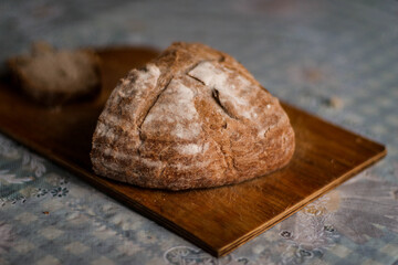 Freshly baked bread on rustic wooden stand.