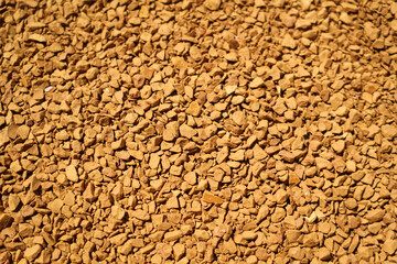 Background of coffee granules at life-size magnification.