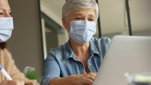 55 year old senior woman with white hair working out with mask