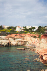 Fototapeta premium Sea Caves, Rocky Coast with a city above