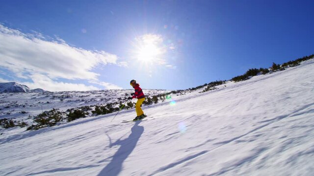 Friends skiing together on slopes on a sunny winter day.