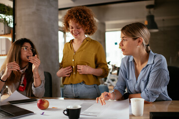 Businesswomen working on a new project. Colleagues discussing about problem they have to solved..