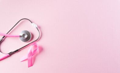 Pink ribbon and stethoscope on pastel pink background, Symbol of womens breast cancer awareness, Health care and medical concept.