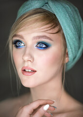 Close-up portrait of a girl with blue makeup.