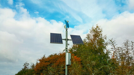 Solar panels in a park isolated on tree background. Energy saving concept.