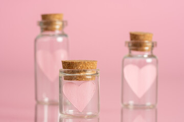Obraz na płótnie Canvas Pink heart in a glass vial