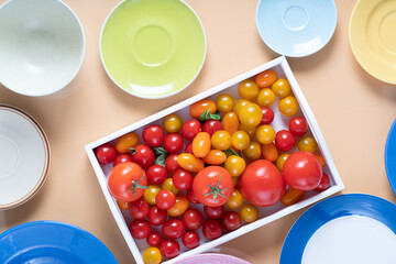Ripe cherry tomatoes in a wooden box.